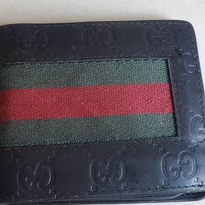 Gucci mens bi-fold wallet in black with green/red stripes.